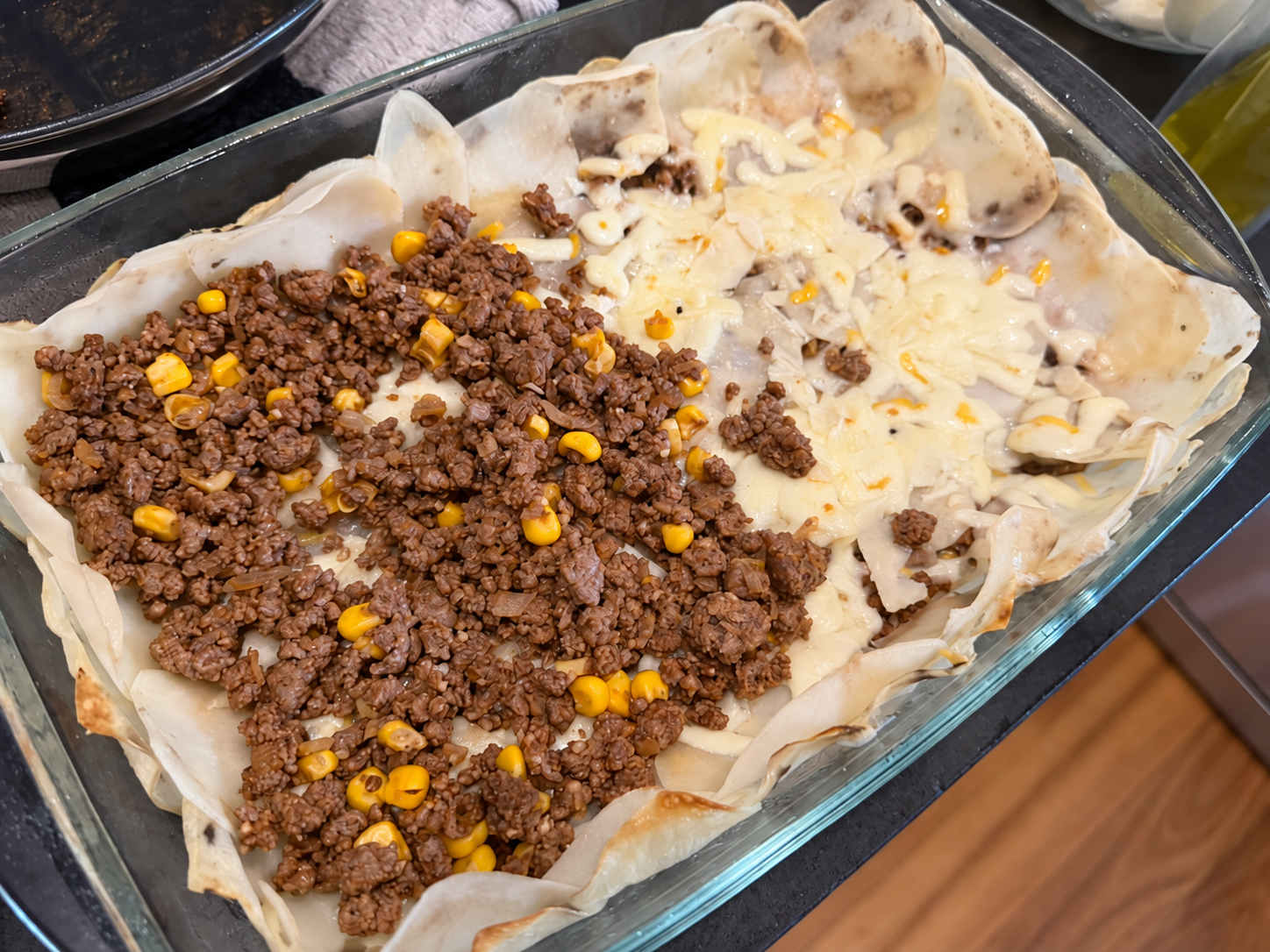 Beef and corn filling between layers of sliced potato