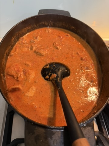 Chicken sauce cooking; the photograph does not show the pasta stage.